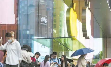  ?? ?? Customers seen at an Apple store in Shanghai in this file photo. — CFP