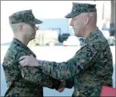  ??  ?? U.S. MARINE CORPS COL. WILLIAM SAUERLAND (right), Marine Aircraft Group 13 commanding officer, shakes hands while speaking with Lt. Col. Michael McKenney.