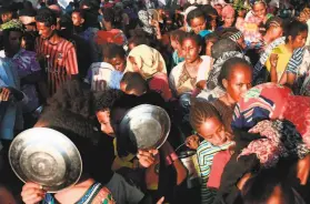  ?? Ebrahim Hamid / AFP / Getty Images ?? Ethiopians who fled intense fighting in the Tigray region wait for food aid Saturday at a refugee encampment in Hamdiyet in eastern Sudan.