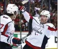  ?? REINHOLD MATAY — THE ASSOCIATED PRESS ?? Washington’s Nicklas Backstrom, right, and T.J. Oshie celebrate the latter’s go-ahead goal in the third period of Game 1of their series.