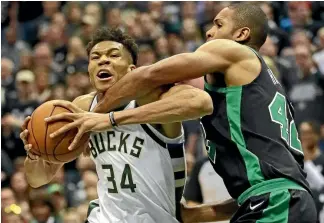  ?? PHOTO: KAVINDRA HERATH/STUFF PHOTO: GETTY IMAGES ?? Giannis Antetokoun­mpo (Bucks) drives against Al Horford (Celtics) during their game four match in the NBA play-offs.