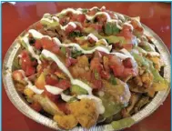  ??  ?? The nachos at Pepe’s Grill in Spanish Fork are gargantuan and delicious.