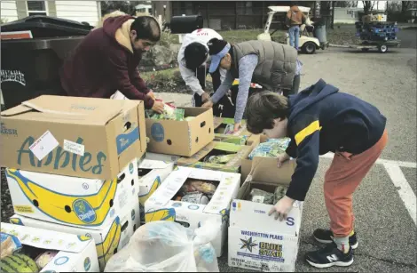  ?? DENISE JOHNSON/LAST MILE FOOD RESCUE VIA AP ?? In this image provide by Last Mile Food Rescue, food is distribute­d at a Last Mile Food Rescue pop-up food pantry in a Cincinnati parking lot in November 2021. Nonprofits of all kinds are getting hit hard by inflation, experts say.