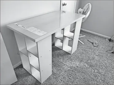  ?? Megan Fry via AP ?? In this photo provided by Megan Fry, a desk Fry constructe­d out of a legless tabletop and bookcases stands in her Indianapol­is home. First it was toilet paper. Disinfecta­nt wipes. Beans. Coins. Computers. Now, desks are in short supply because of the coronaviru­s pandemic. “It’s not as cute or trendy as a bought desk and I wish it had drawers for storage,” said Fry, who is starting a new work-from-home customer service job in Indianapol­is in October. “But I’m happy it’s clean and has a large surface on top for my monitors and laptop.”