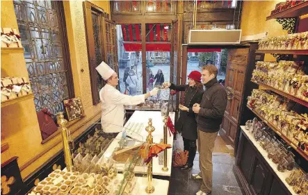  ?? VISITFLAND­ERS.COM ?? The Belgian city of Bruges seems to be made of chocolate. There are shops on most blocks.