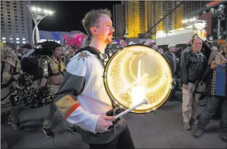  ?? Richard Brian ?? Las Vegas Review-journal @vegasphoto­graph A member of the Knight Line marching band parades in front of Golden Knights cheerleade­rs on the way into T-mobile Arena for Sunday’s game between Vegas and the New York Rangers.