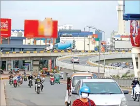  ?? HENG CHIVOAN ?? A billboard advertisin­g beer is seen on an overpass in Phnom Penh.