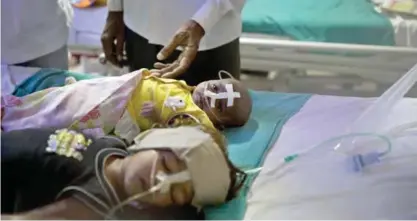  ?? — AP ?? GORAKHPUR: Children receive treatment at the state-run Baba Raghav Das Medical College Hospital where 35 children died in three days.