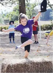  ??  ?? Lorelei Perry flies over the first hay bale.