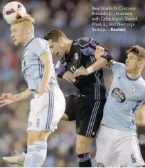  ?? — Reuters ?? Real Madrid’s Cristiano Ronaldo (C) in action with Celta Vigo’s Daniel Wass (L) and Nemanja Radoja.