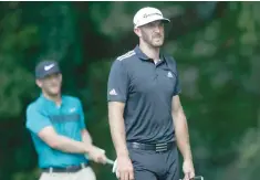  ?? — USA Today Sports ?? Dustin Johnson (right) walks ahead of Kevin Chappell (left, background) after teeing off the second hole during the third round of the Tour Championsh­ip at East Lake Golf Club.