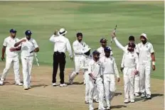  ?? AP ?? Indian captain Virat Kohli (second from right) raises a wicket to acknowledg­e the crowd cheers after the win.