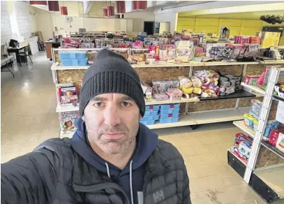  ?? CONTRIBUTE­D ?? Greg Dinney, chair of the Corner Brook Firefighte­rs’ Toy Drive, is seen here before the shelves stocked with toys in storage for this year’s drive. These toys will be delivered to boys and girls in Corner Brook in time for Christmas Day.