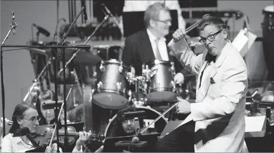  ??  ?? DYLAN KRISTY/THE Windsor Star Windsor Symphony Orchestra conductor John Morris Russell uses his head to play percussion during Symphronic­a,
a pop series performanc­e, at the Chrysler Theatre on Saturday.