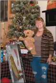  ?? Donnis Hueftle-Bullock ?? At right, Dana Smith of Shotgun Annie’s in Callaway stands by the Christmas tree and the toys shoppers brought for their Toys for Tots program. Shotgun Annie’s works with Callaway School teachers who choose toys for students they know need additional assistance. Any toys left over go the Healing Hearts and Families program.