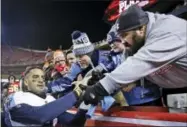  ?? CHARLIE RIEDEL — THE ASSOCIATED PRESS ?? Tennessee Titans quarterbac­k Marcus Mariota celebrates with fans after the team’s NFL wild-card playoff football game against the Kansas City Chiefs on Saturday in Kansas City, Mo. The Titans won 22-21.