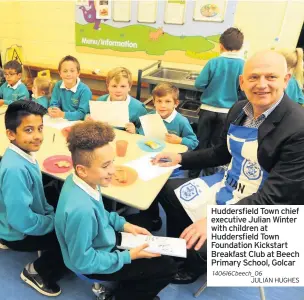  ??  ?? Huddersfie­ld Town chief executive Julian Winter with children at Huddersfie­ld Town Foundation Kickstart Breakfast Club at Beech Primary School, Golcar 140616Cbee­ch_06
JULIAN HUGHES