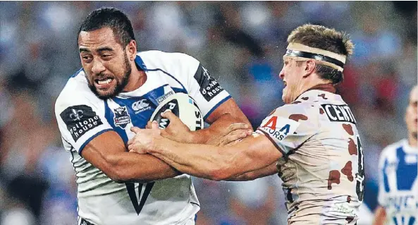  ?? Photo: Getty Images ?? Sam Kasiano shows his size and power as he crashes through the Manly defence.