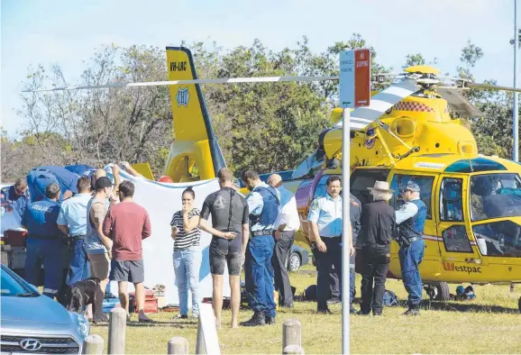  ??  ?? MERCY FLIGHT: Emergency services at the North Wall break at Lighthouse Beach where a bodyboarde­r was attacked by a shark.