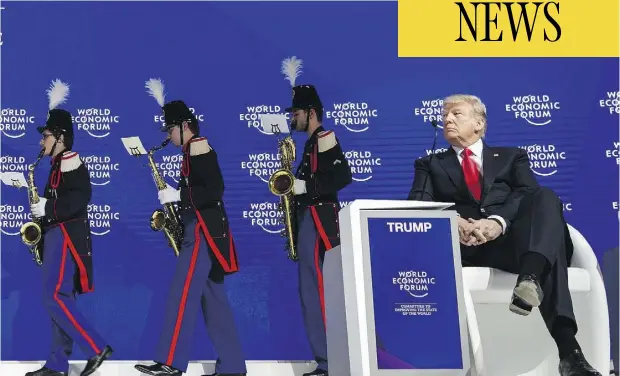  ?? FABRICE COFFRINI / AFP / GETTY IMAGES ?? U.S. President Donald Trump watches a band leave the stage before delivering his speech to the World Economic Forum annual meeting in Davos, Switzerlan­d, on Friday, where he touted the U.S. as a trading partner.