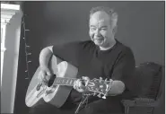  ?? AP ?? John Prine plays guitar in his Nashville, Tenn., office.