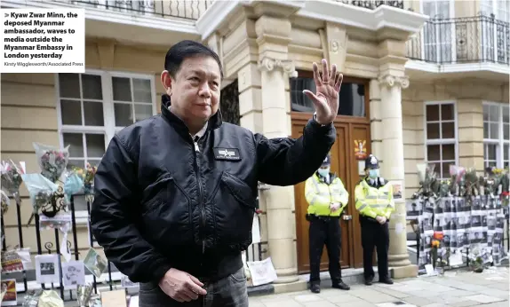  ?? Kirsty Wiggleswor­th/Associated Press ?? > Kyaw Zwar Minn, the deposed Myanmar ambassador, waves to media outside the Myanmar Embassy in London yesterday