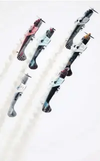  ??  ?? Up and over: The Aerostars gave a wonderfull­y colourful display of close formation aerobatics.
