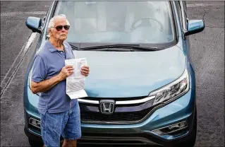  ?? DAMON HIGGINS / THE PALM BEACH POST ?? Leo Solar of West Palm Beach shows his stack of insurance bills. “PIP is worthless,” he said. “It’s just like throwing your money away.”