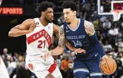  ?? BRANDON DILL / AP ?? Guard Danny Green (right, defended by Toronto Raptors forward Thaddeus Young earlier this month while playing for the Memphis Grizzlies) could be bound for Cleveland, according to reports.