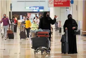  ?? — AFP ?? Travellers at the dubai Internatio­nal airport, a major aviation hub that will most likely benefit from the football tournament in Qatar.