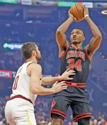  ?? TONY DEJAK/AP ?? Bulls center Wendell Carter Jr., who had 15 points and eight rebounds against the Cleveland Cavaliers on Wednesday night, shoots over Kevin Love in the first half.