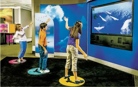  ?? OSCAR WILLIAMS PHOTOS ?? One exhibit allows visitors to flap their arms like wings to see themselves as birds on a video monitor (above), and they can also learn about spacecraft of the future (left).