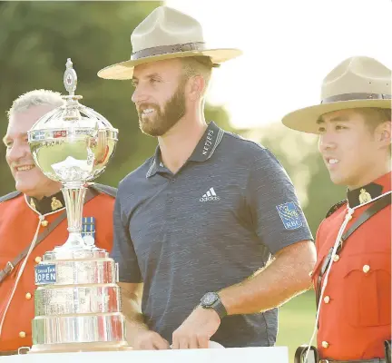  ?? THE CANADIAN PRESS ?? Dustin Johnson dons an RCMP Stetson before hoisting the Canadian Open championsh­ip trophy at Glen Abbey on Sunday.