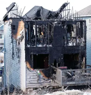  ?? TED PRITCHARD / REUTERS ?? Seven children died in an early morning fire Tuesday at this house in the Halifax suburb of Spryfield, the worst fire toll in recent memory in Nova Scotia. “It’s just something out of a horror movie,” said next-door neighbour Danielle Burt.