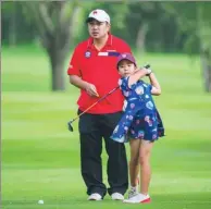  ?? PROVIDED TO CHINA DAILY ?? Liu Guoliang spends time honing his daughter’s golf skills.