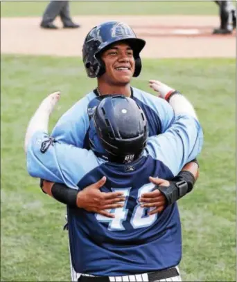  ?? JOHN BLAINE — FOR THE TRENTONIAN ?? Thunder’s Thairo Estrada, back, hugs bat boy Tommy Smith, front, after scoring a run in the fourth inning of Sunday’s first game against Erie.