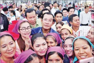  ?? FACEBOOK ?? Prime Minister Hun Sen poses for a selfie with garment workers during a visit to a factory in Phnom Penh yesterday.