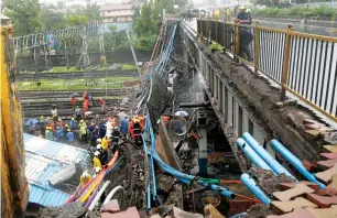  ?? AP ?? Rescuers work at the site of a foot bridge that collapsed at the Andheri railway station on Tuesday. —