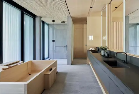  ??  ?? Above — The guest bathroom design is formal and centred around a hinoki (cypress) ofuro, or bathing tub.