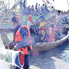  ??  ?? File photo shows Myanmar Navy personnel escorting a group of Rohingya Muslims back to their camp in Sittwe, Rakhine state. — AFP photo