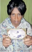  ?? SUPPLIED ?? GERALDINE Swartz holds up a photograph of herself and her son Max Bruintjies, who went missing in 2003. |