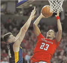  ?? AP PHOTO ?? TO THE TIN: Texas Tech’s Jarrett Culver shoots over West Virginia’s Chase Harler yesterday.