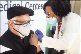  ??  ?? Nurse Marie St. Jean administer­s a vaccinatio­n to Bishop John Diamond, of the Cathedral of Faith.