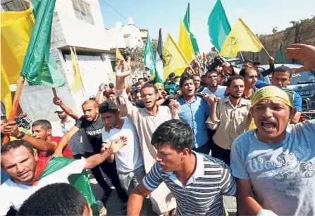  ?? — AFP ?? Seeking justice: Mourners at the funeral of Palestinia­n Abdullah Dagma, who was killed the day before during a protest along the Israel- Gaza border fence.