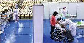  ?? REUTERS ?? A medical worker administer­s a dose of the Astrazenec­a vaccine against the coronaviru­s disease to a man during a vaccinatio­n session for elderly people over 85 years old, at an auditorium in New Taipei City, Taiwan, on Wednesday.