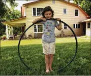  ?? CAROLYN COLE / LOS ANGELES TIMES ?? Joy Elizabeth Reilly, 8, holds a hula hoop 42 inches in diameter, the size of the pipeline proposed to run through her parents’ farm in Virginia.