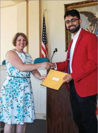  ?? SUBMITTED PHOTO ?? Catherine Friedman, of the Friends Associatio­n, presents the Presidenti­al Service Award to Mohammad Farooq, West Chester University student and Friars Club president.