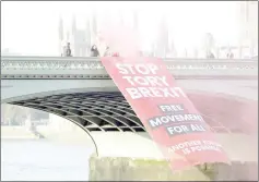  ?? — Reuters photo ?? Protesters unfurl a banner on Westminste­r Bridge before an antiBrexit demonstrat­ion, in central London.