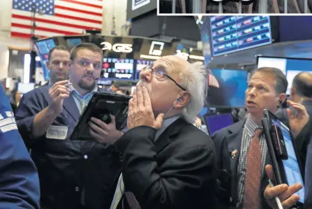  ??  ?? AP SOURED: Peter Tuchman, above center, works with fellow traders on the floor of the New York Stock Exchange, Friday. Wall Street has suddenly soured on Silicon Valley and the rest of tech, including Apple, top, triggering a stomach-churning downturn likely to leave millions queasy, should they check the damage to their investment portfolios in October.