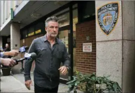  ?? PHOTO — JULIE JACOBSON ?? Actor Alec Baldwin walks out of the New York Police Department’s 10th Precinct, Friday in New York. Baldwin was arrested Friday after allegedly punching a man in the face during a dispute over a parking spot outside his New York City home, authoritie­s said.